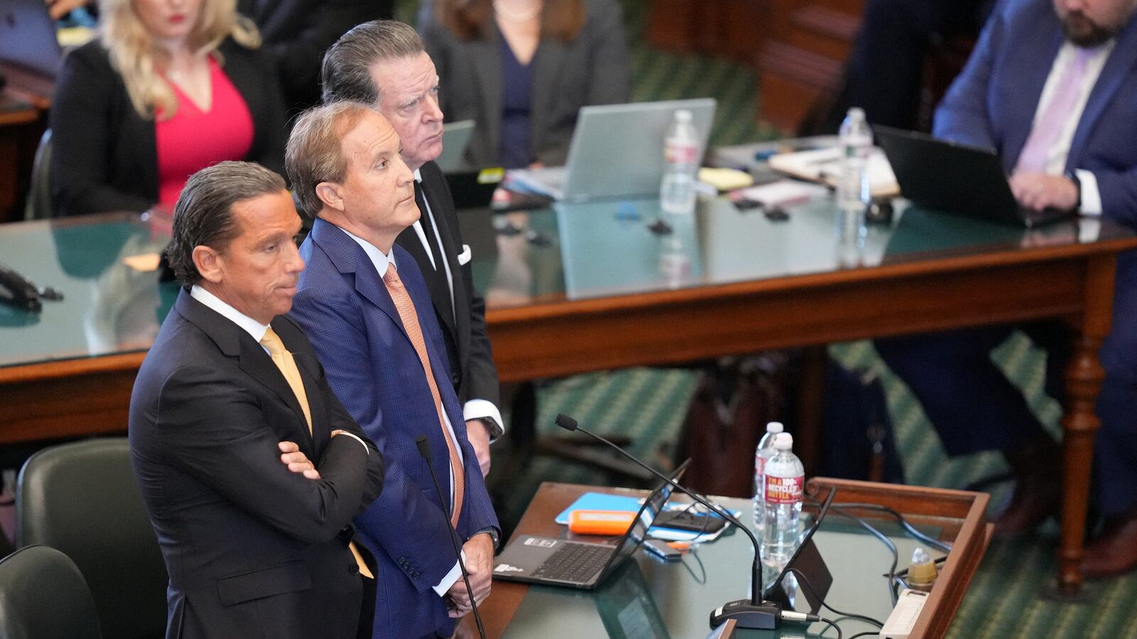 Attorney General Ken Paxton, middle, with his attorneys Tony Buzbee and Dan Cogdell