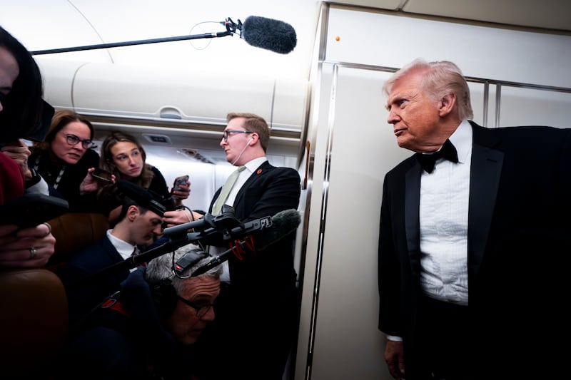 President Donald Trump speaks to reporters and members of the media on board Air Force One on January 31, 2026 while flying in between Washington and West Palm Beach, Florida.