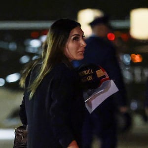 JOINT BASE ANDREWS, MARYLAND - OCTOBER 02: Political activist Laura Loomer follows behind U.S. President Donald Trump as he walks off Air Force One on October 02, 2026 in Joint Base Andrews, Maryland. Trump travelled to Mobile, Alabama for a campaign rally. (Photo by Anna Moneymaker/Getty Images)