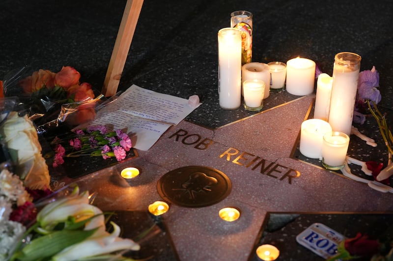 Flowers and candles are placed on director/actor Rob Reiner's Star on the Hollywood Walk of Fame.