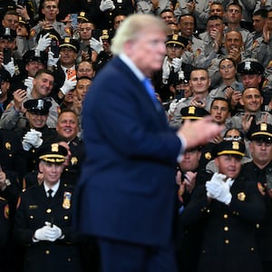 Law enforcement members applaud US President Donald Trump as he departs after delivering remarks at the Nassau County Police Academy Center for Training and Intelligence in Garden City, New York, on August 14, 2026.