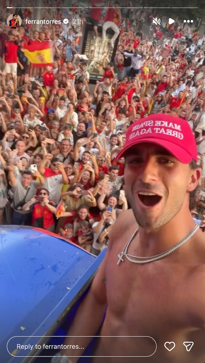 Ferran Torres wears 'Make Spain Great Again' hat in celebratory parade on Monday following World Cup win.