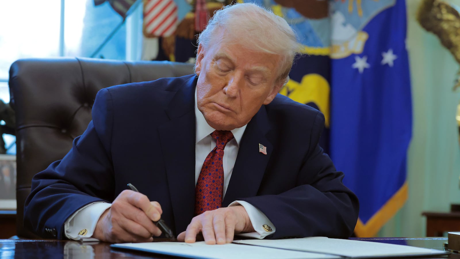 WASHINGTON, DC - DECEMBER 15: U.S. President Donald Trump signs an executive order classifying fentanyl as a "weapon of mass destruction," during a ceremony for the presentation of the Mexican Border Defense Medal in the Oval Office of the White House on December 15, 2025 in Washington, DC. During the ceremony, Trump recognized the first 13 service members to receive the recently established Mexican Border Defense Medal (MBDM), which recognizes service members supporting Customs and Border Protection on the U.S.-Mexico border. (Photo by Anna Moneymaker/Getty Images)