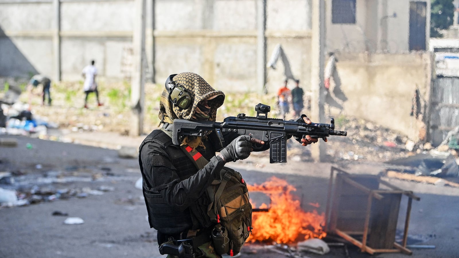 A policeman points a gun at protesters during a demonstration calling for the resignation of Prime Minister Ariel Henry in Port-au-Prince last month.