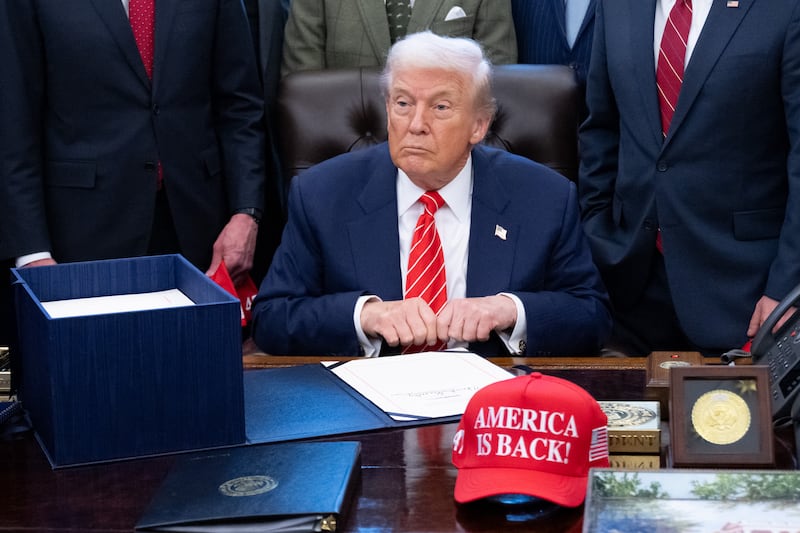 President Donald Trump signs a funding bill to end a partial government shutdown in the Oval Office of the White House in Washington, DC, on February 3, 2026.