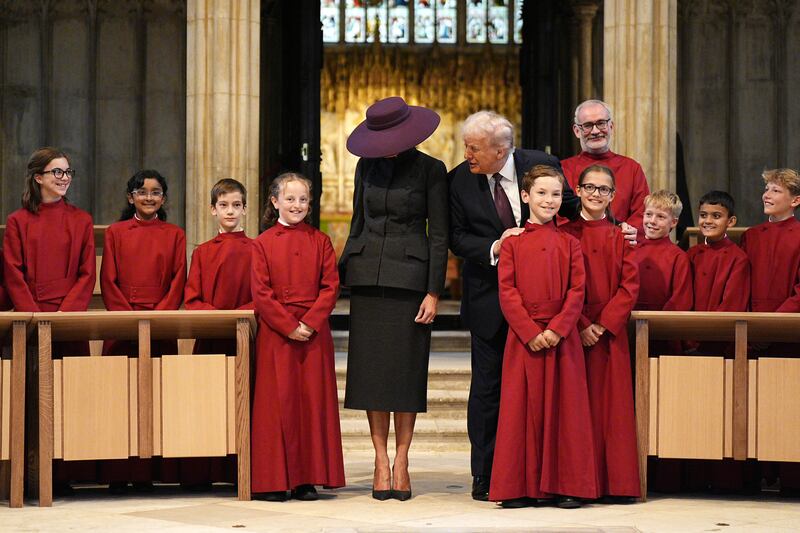 WINDSOR, ENGLAND - SEPTEMBER 17: US President Donald Trump and First Lady Melania Trump meet young members of the choir during a visit to St George's Chapel at Windsor Castle during the State visit by the President of the United States of America on September 17, 2025 in Windsor, England. (Photo by Aaron Chown - WPA Pool/Getty Images)