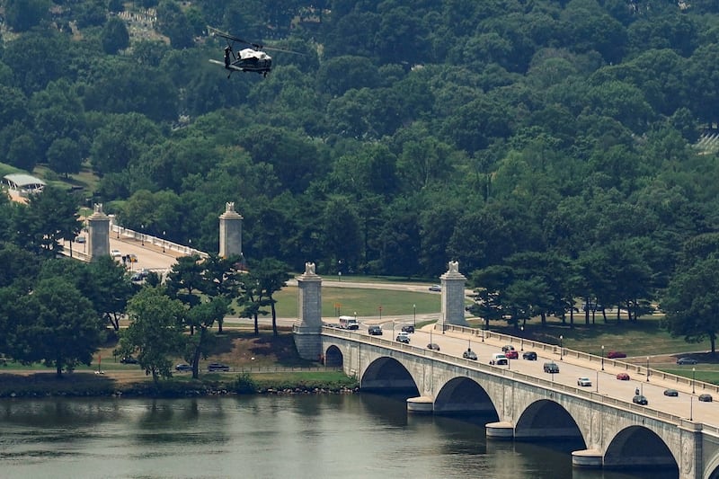 Marine One, carrying U.S. President Donald Trump, flies over Memorial Circle, the location of the proposed U.S. Triumphal Arch, near Arlington National Cemetery, the Potomac River, and the Arlington Memorial Bridge, while departing for Pennsylvania, in Washington, D.C., U.S., July 15, 2026 REUTERS/Al Drago          TPX IMAGES OF THE DAY
