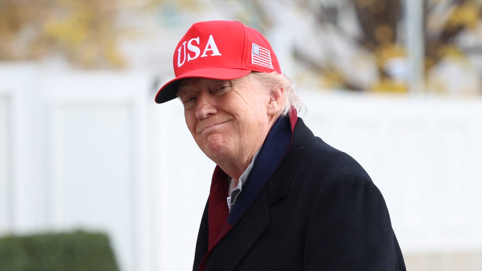 US President Donald Trump smiles as he walks from Marine One to the White House after landing on the South Lawn in Washington, DC, on November 22, 2025. Trump is returning to the White House after taking an aerial tour of The Courses at Joint Base Andrews, Maryland. (Photo by Alex WROBLEWSKI / AFP via Getty Images)