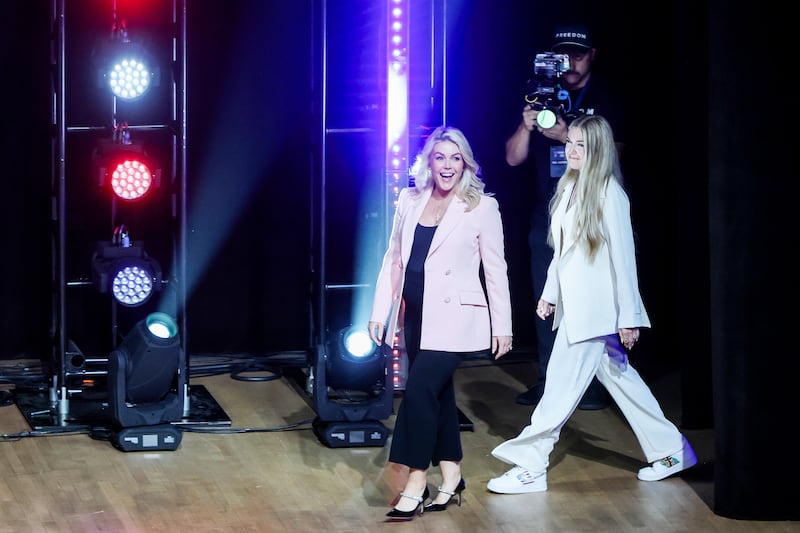 WASHINGTON, DC - APRIL 02: C.E.O. and Chair of the Board of Turning Point USA Erika Kirk (R) and White House Press Secretary Karoline Leavitt (L) walk onstage before having a conversation as part of a Turning Point USA stop in the Lisner Auditorium at George Washington University on April 02, 2026 in Washington, DC. The conservative youth organization kicked off their Spring tour, which will visit multiple cities. (Photo by Anna Moneymaker/Getty Images)