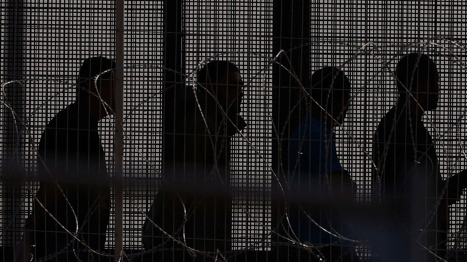 Migrants stand near the border wall after having crossed the U.S.-Mexico border to turn themselves in to U.S. Border Patrol agents as seen from Ciudad Juarez, Mexico, May 12, 2023.