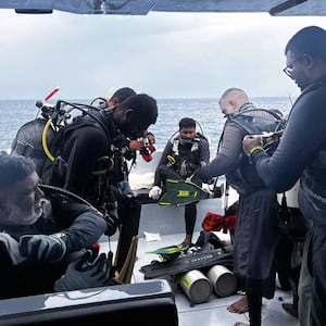 Divers preparing to search for the bodies of missing Italian divers in the Maldives