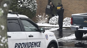 COVENTRY, UNITED STATES - DECEMBER 14: FBI agents and law enforcement officials canvass the scene for clues where the suspect in the Brown University shooting was arrested at Hampton Inn Coventry Warwick in Coventry, R.I., Sunday, Dec. 14, 2025. FBI agents and other law enforcement personnel descended on the hotel early Sunday morning following a mass shooting that killed two people and wounded nine others at Brown University in the Providence neighborhood Saturday. Authorities are raiding the hotel and have set up police tape at the crime scene. (Photo by Kyle Mazza/Anadolu via Getty Images)