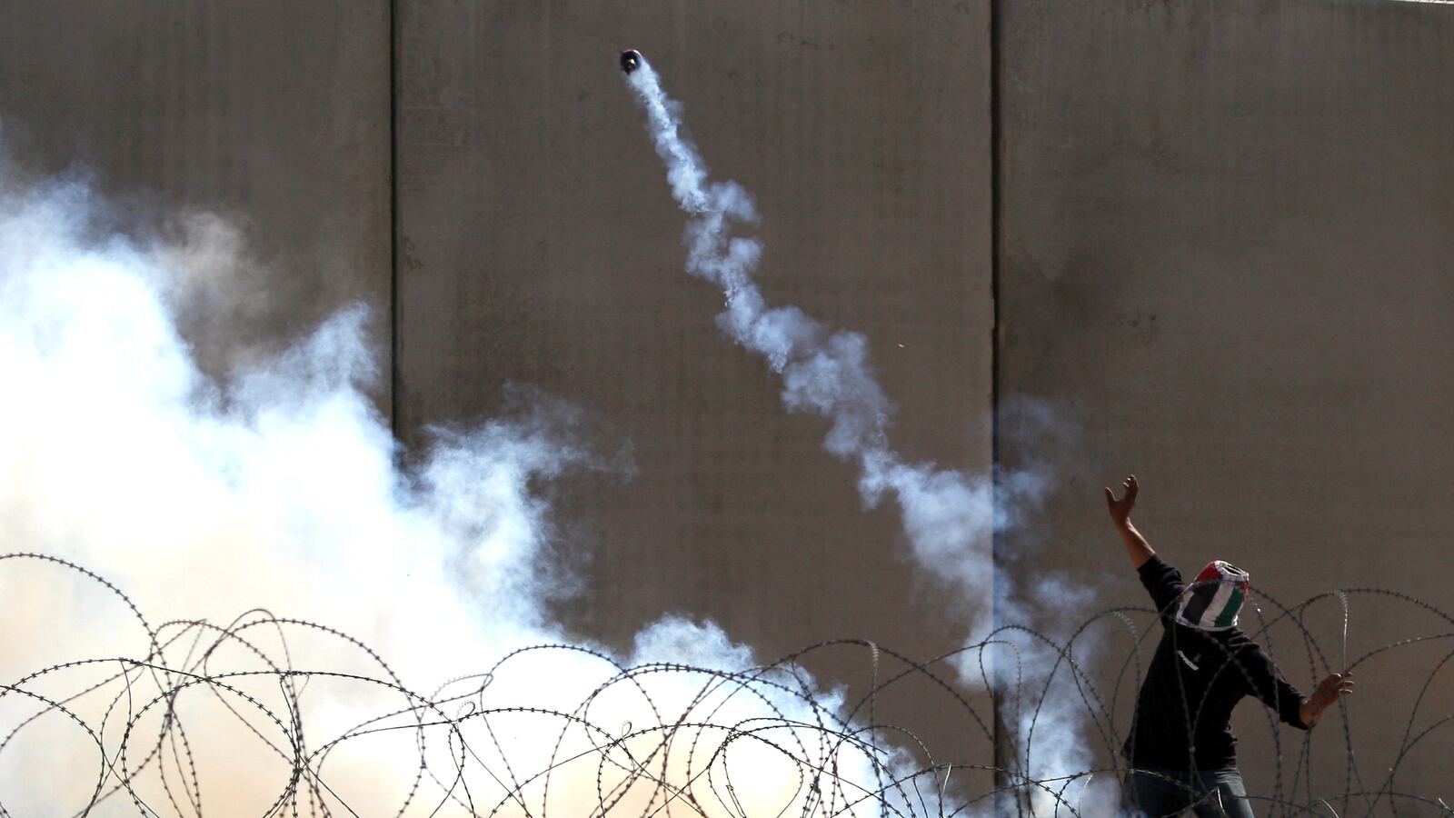 articles/2013/04/02/after-victory-palestinian-village-runs-into-a-wall/bilin-teargas-openz_dcjq7i