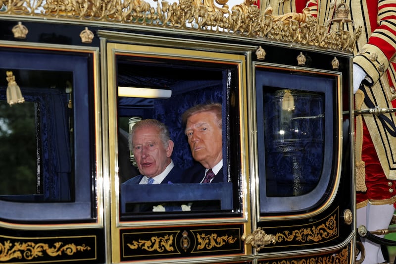 King Charles and President Donald Trump sit in a carriage during a procession through Windsor Castle on Wednesday.