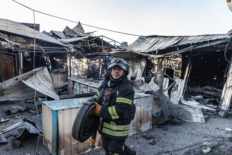 Ukrainian firefighters extinguish a fire in the Kostiantynivka market, which broke out after a Russian shelling of the city, in Kostiantynivka, Ukraine, 21 August 2025.