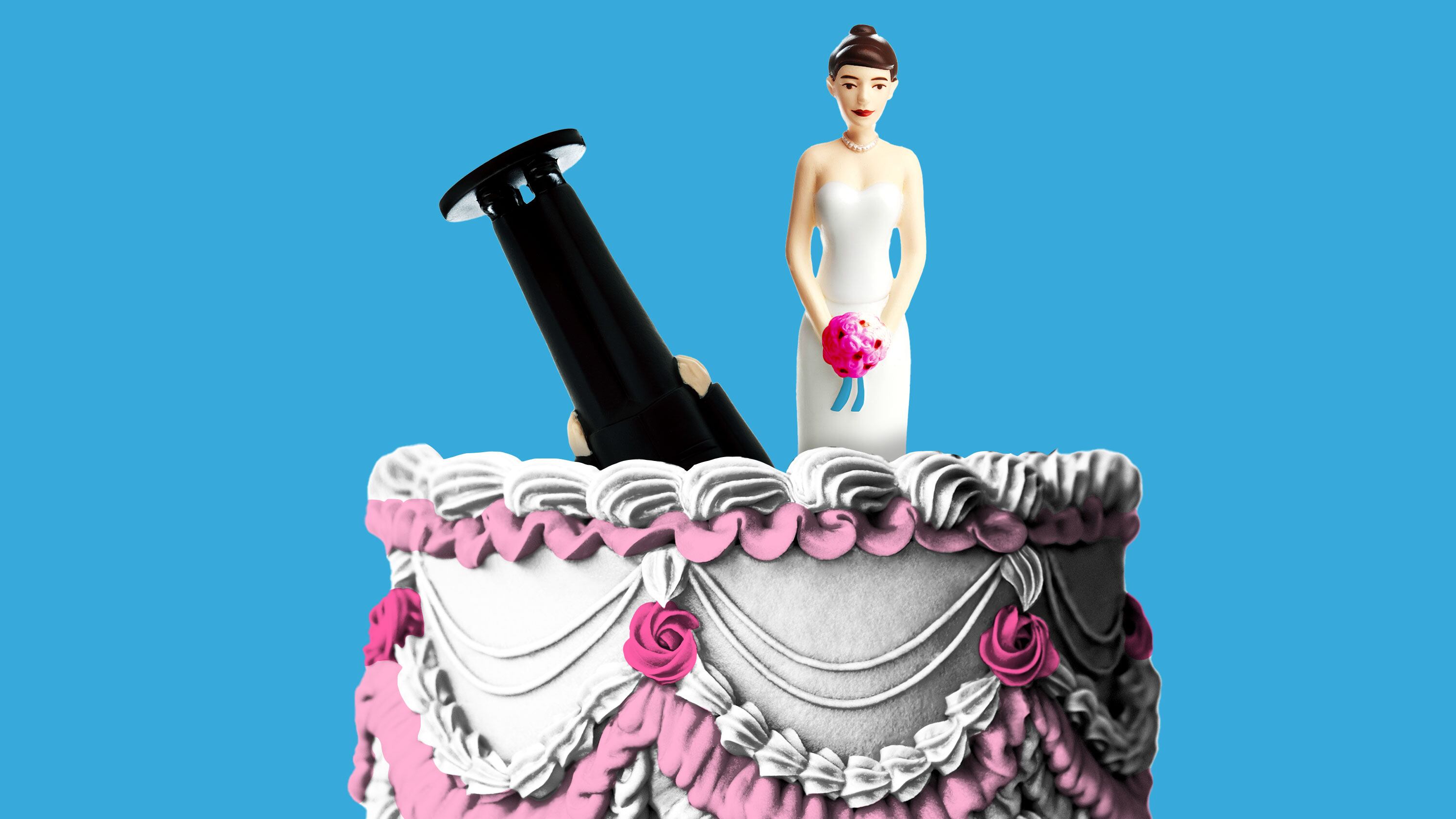 Bride and groom cake topper on a vintage wedding cake with the groom upside down