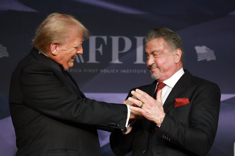 PALM BEACH, FLORIDA - NOVEMBER 14: U.S. President-elect Donald Trump greets actor Sylvester Stallone onstage at the America First Policy Institute Gala held at Mar-a-Lago on November 14, 2024 in Palm Beach, Florida. The annual event supports Grey Team, a nonprofit organization dedicated to preventing military suicide. (Photo by Joe Raedle/Getty Images)