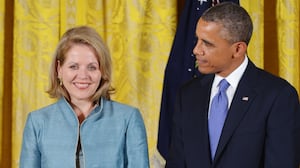 Then U.S. President Barack Obama smiles while standing with 2012 National Medal of Arts recipient soprano Renée Fleming.