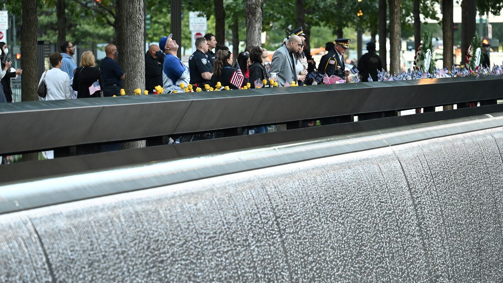 Mourners stand at the South Tower ahead ceremonies commemorating the 20th anniversary of the September 11 attacks, in New York City, U.S., September 11, 2021.