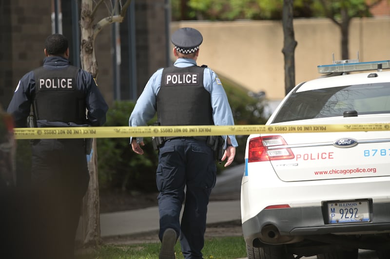 Chicago police officers wait for updates on two fellow officers who were shot during a prisoner transport incident in Chicago on April 25, 2026.