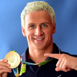 RIO DE JANEIRO, BRAZIL - AUGUST 12:  (BROADCAST - OUT) Swimmer, Ryan Lochte of the United States poses for a photo with his gold medal on the Today show set on Copacabana Beach on August 12, 2016 in Rio de Janeiro, Brazil.  (Photo by Harry How/Getty Images)