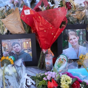 Providence, RI - December 18: Photographs of victims MukhammadAziz Umurzokov and Ella Cook at a memorial set up by Brown University outside of the Barus and Holley building on December 18, 2025.