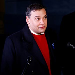 George Santos (R-NY) talks to reporters while walking to attend a vote on whether the House of Representatives will expel him