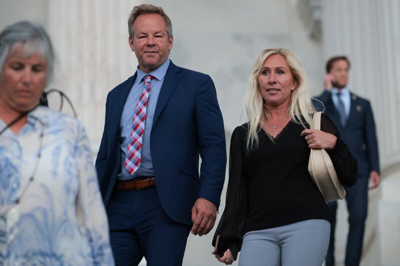 WASHINGTON, DC - MAY 05: Brian Glenn with Real America’s Voice (L) walks alongside girlfriend, U.S. Rep. Marjorie Taylor Greene (R-GA) (R) down the U.S. Capitol steps after voting on May 05, 2025 in Washington, DC. The House reconvened after the weekend to vote on the Aviator Cancers Examination Study (ACES) Act and Mobilizing and Enhancing Georgia’s Options for Building Accountability, Resilience, and Independence (MEGOBARI) Act, which both passed. (Photo by Kayla Bartkowski/Getty Images)