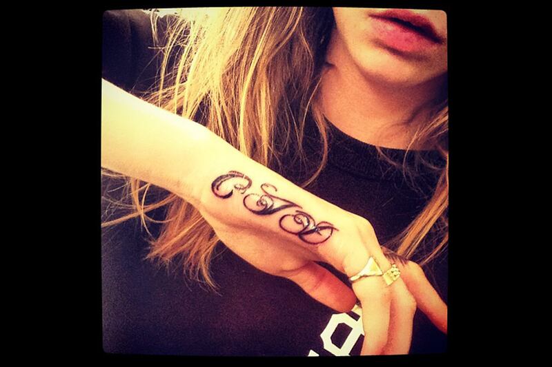 articles/2013/05/22/cara-delevingne-gets-another-tattoo-fashion-influencers-top-forbes-most-powerful-women/130522-cara-delevingne-cheat_ndrlht