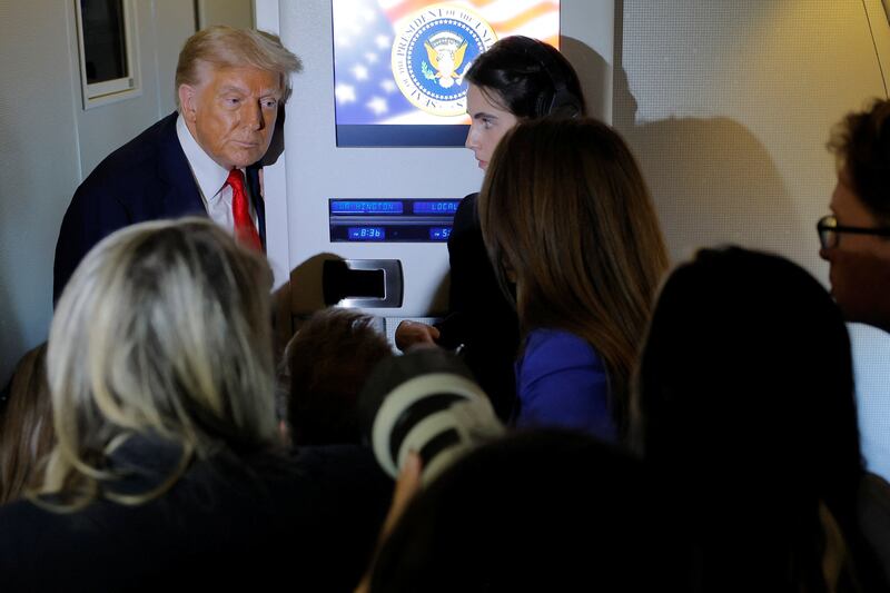 Donald Trump speaks to reports aboard Air Force One.