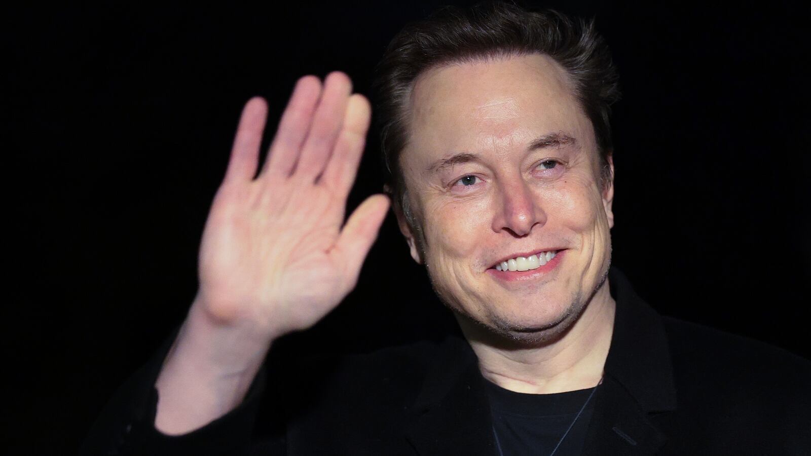 Elon Musk holds a stuffed toy