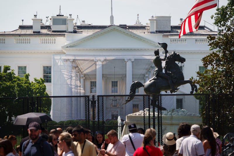 WASHINGTON, DC - AUGUST 9: Security fencing surrounds Lafayette Square and the White House as a protective tarp with a photo on it covers scaffolding and the columns on the North Portico as part of a construction project on August 9, 2026 in Washington, DC.. (Photo by Kevin Carter/Getty Images)