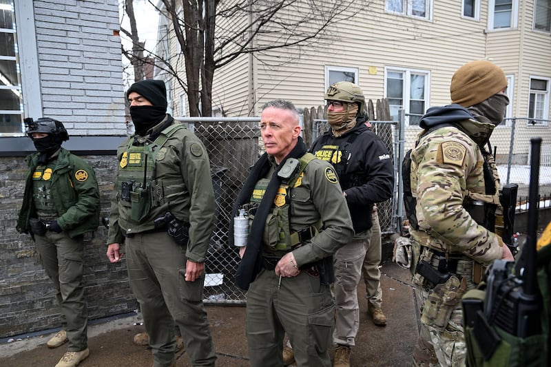 MINNEAPOLIS, MN - JANUARY 8: Border Patrol Chief Greg Bovino (C) and his agents watch as people taunt them during an arrest  along Franklin Avenue before arresting him on January 8, 2026 in Minneapolis, Minnesota. Yesterday along Portland Avenue and 34th Street Renee Nicole Good was fatally shot by an Immigration and Customs Enforcement officer during a federal law enforcement operation. (Photo by Joshua Lott/The Washington Post via Getty Images)