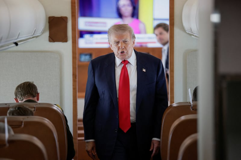 U.S. President Donald Trump speaks to reporters aboard Air Force One en route to Michigan, U.S., July 27, 2026. REUTERS/Evan Vucci