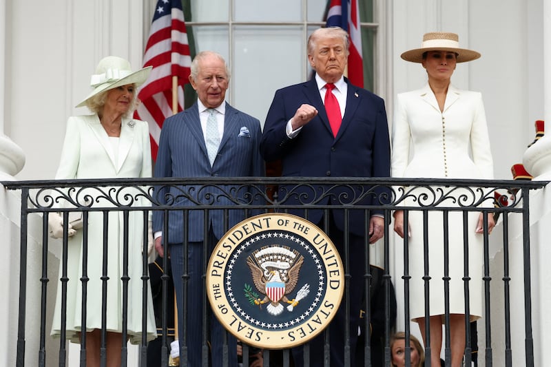 U.S. President Donald Trump, Britain's King Charles, Queen Camilla and U.S. first lady Melania Trump watch a pass in review during an arrival ceremony for the king and queen on the South Lawn of the White House, in Washington, D.C., U.S., April 28, 2026. REUTERS/Kevin Lamarque