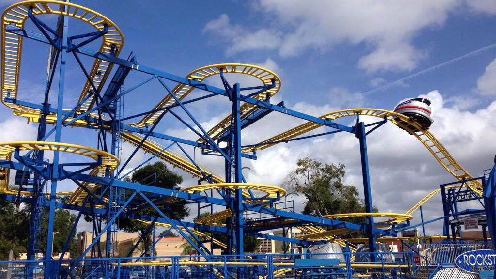 A blue and yellow rollercoaster at a Florida theme park.