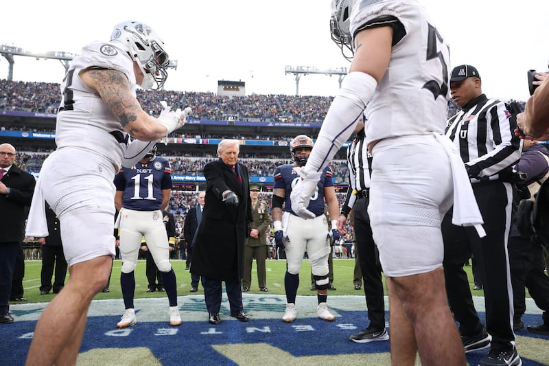 U.S. President Donald Trump participates in the coin toss before the start of the 126th Army-Navy Game between the Army Black Knights and the Navy Midshipmen at M&T Bank Stadium on December 13, 2025 in Baltimore, Maryland.