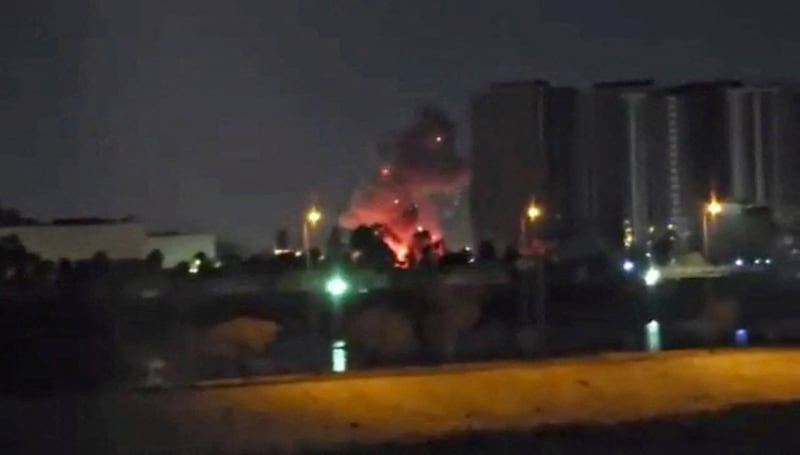 Smoke and fire rise during reported drone and rocket strikes at the U.S. embassy, according to Iraqi security sources, in Baghdad, Iraq, in this still image obtained from a social media video released March 17, 2026. Social Media via REUTERS  THIS IMAGE HAS BEEN SUPPLIED BY A THIRD PARTY. NO RESALES. NO ARCHIVES. NEWS USE ONLY. TPX IMAGES OF THE DAY        VERIFICATION: Reuters was able to confirm the location from buildings, road layout, water body, the construction crane and the pillar of the restaurant which matched file and satellite image.  The strike happened within the vicinity of coordinates at 33.29897989833943, 44.38517051381258.  Exact time was not verified but no older version of the video was found posted online before March 17.  Security sources confirmed that drones and rockets attacked the US embassy in Baghdad on March 17.