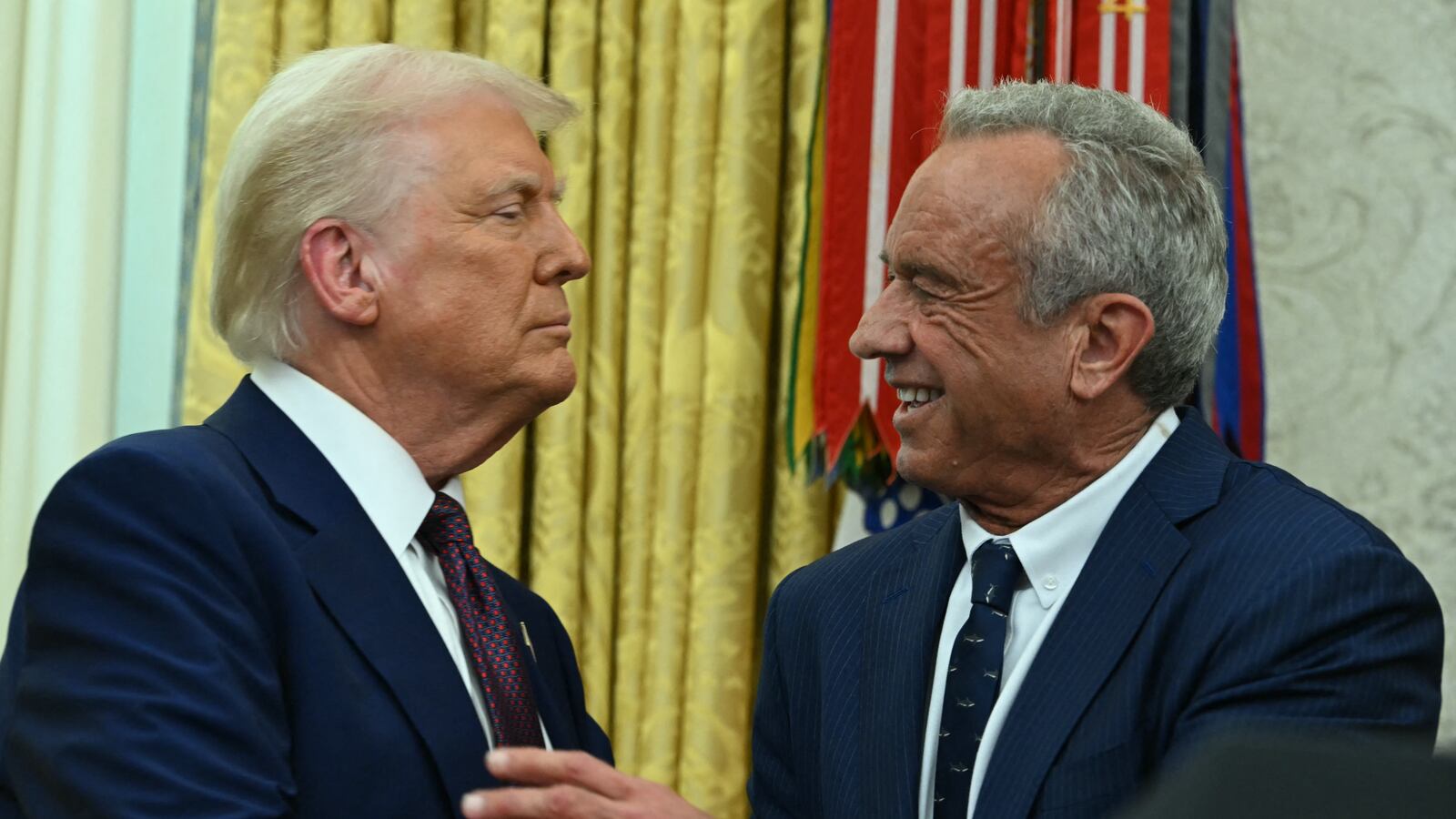 US Secretary of Health and Human Services Robert F. Kennedy Jr., shakes hands with US President Donald Trump after a swearing in ceremony in the Oval Office of the White House in Washington, DC, on February 13, 2025.
