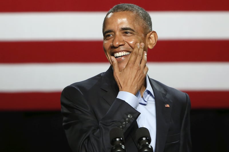 U.S. President Barack Obama laughs while joking about Republican presidential candidate Donald Trump's personal brand of wine as he delivers remarks to supporters at a Democratic National Committee (DNC) event at Gilley's Club in Dallas, Texas March 12, 2016.