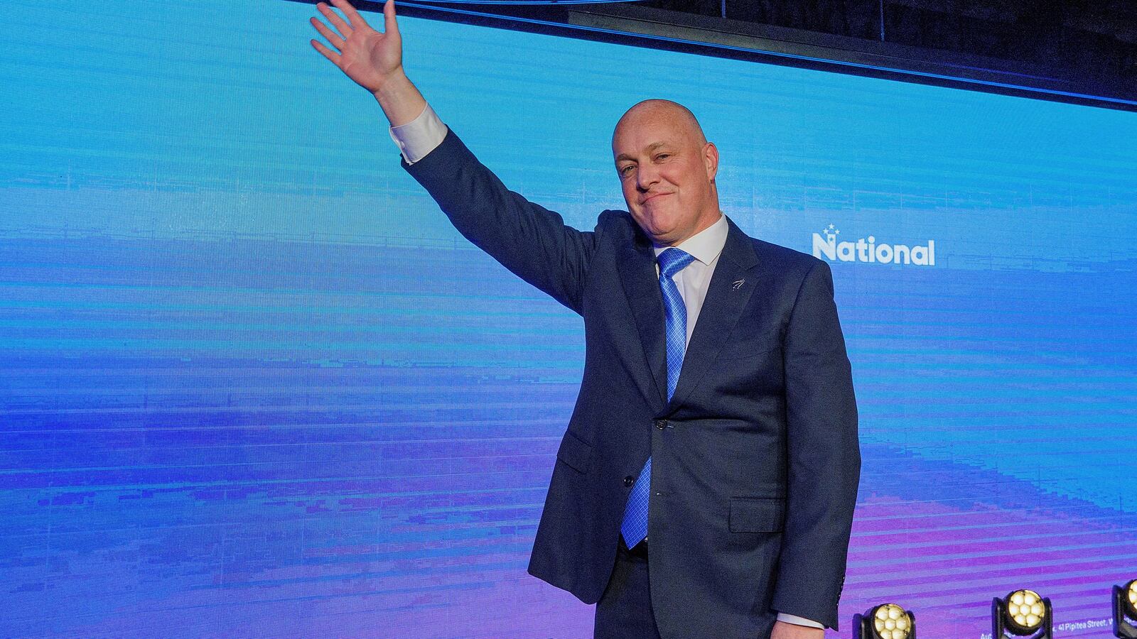 Christopher Luxon, leader of New Zealand's National Party waves to supporters at his election party.