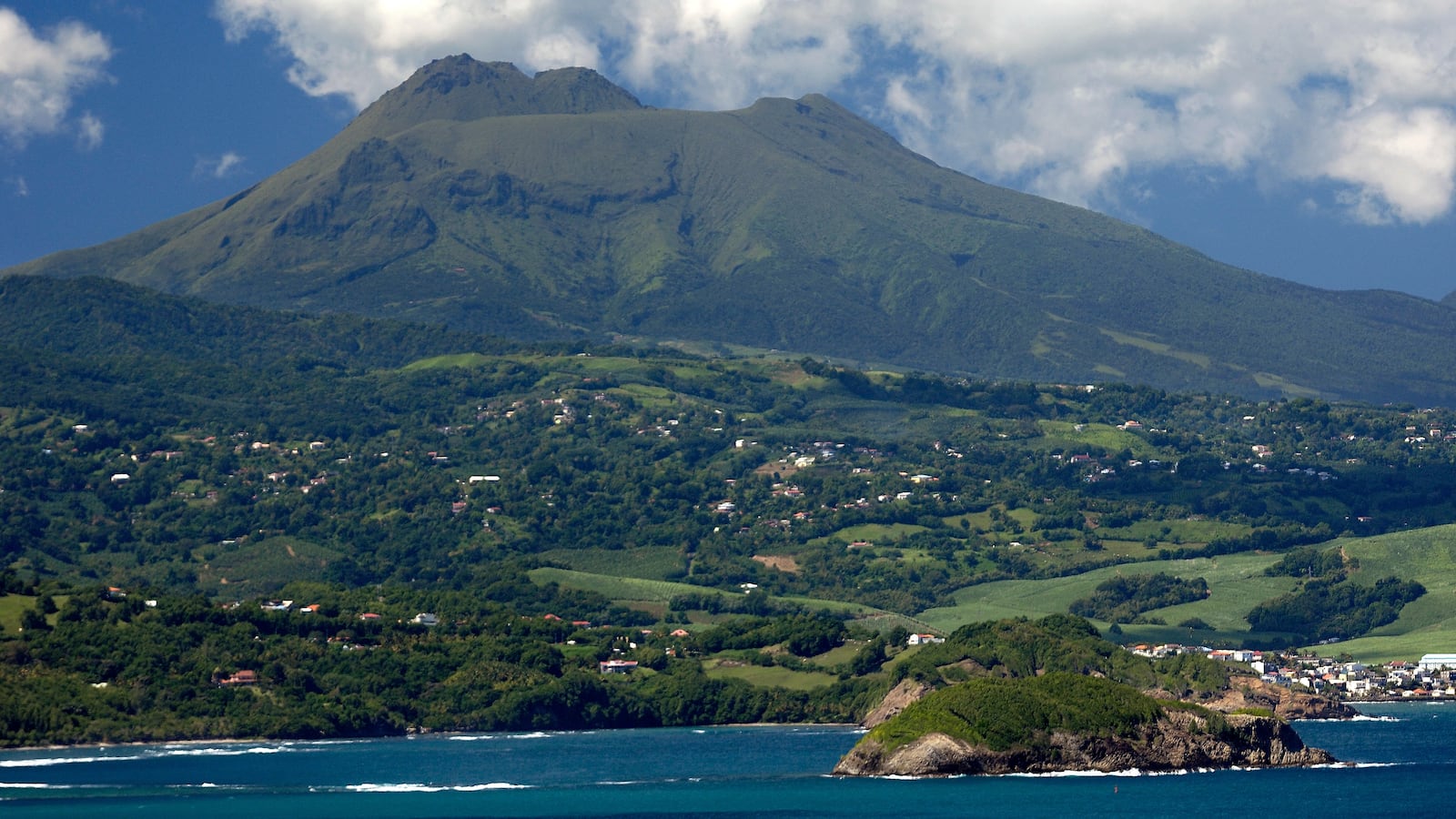 Tartane island with Mount Pelée in the background dominating Robert Bay. (Photo by philippe giraud/Corbis via Getty Images)