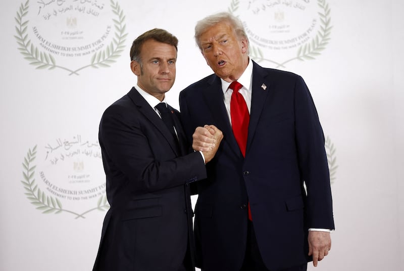 Donald Trump and French President Emmanuel Macron shake hands as they pose for a photo in Sharm el-Sheikh, Egypt, October 13, 2025.