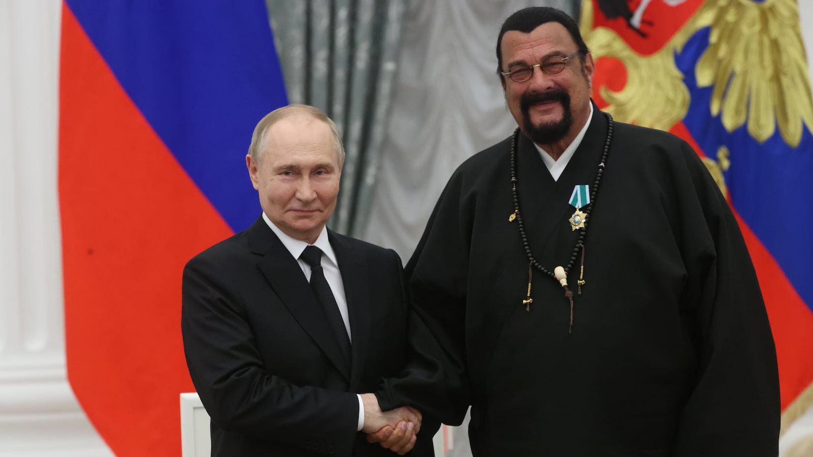 Russian President Vladimir Putin greets Steven Seagal