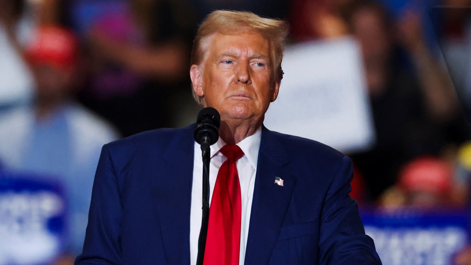 Donald Trump stares forward on stage at a campaign event.