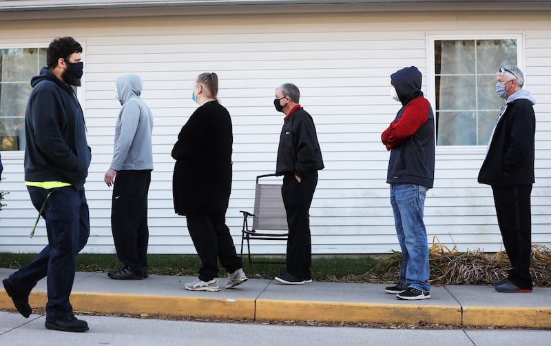 People stand in line to vote outside Bloomfield United Methodist Church on November 3, 2020, in Des Moines, Iowa.