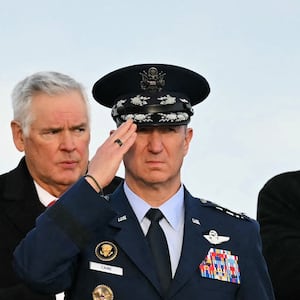 US President Donald Trump, Defense Secretary Pete Hegseth and Chairman of the Joint Chiefs of Staff Gen. Dan Caine salute during a ceremony for the return of the remains of two Iowa National Guard members and a translator killed in an attack in Syria at Dover Air Force Base in Delaware on December 17, 2025. (Photo by ANDREW CABALLERO-REYNOLDS / AFP)