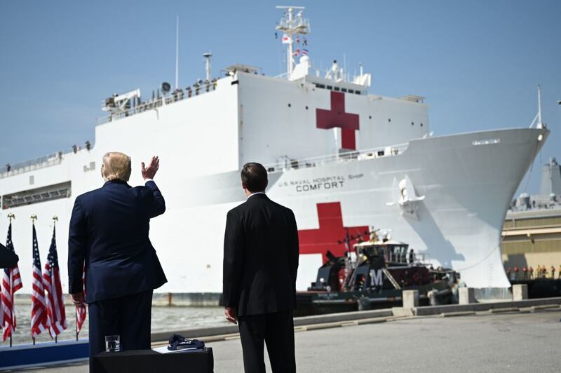 US Defense Secretary Mark Esper (R) and US President Donald Trump watch as the hospital ship USNS Comfort departs Naval Base Norfolk on March 28, 2020, in Norfolk, Virginia. - The Comfort sails to New York City to aid in the coronavirus outbreak. (Photo by JIM WATSON / AFP) (Photo by JIM WATSON/AFP via Getty Images)