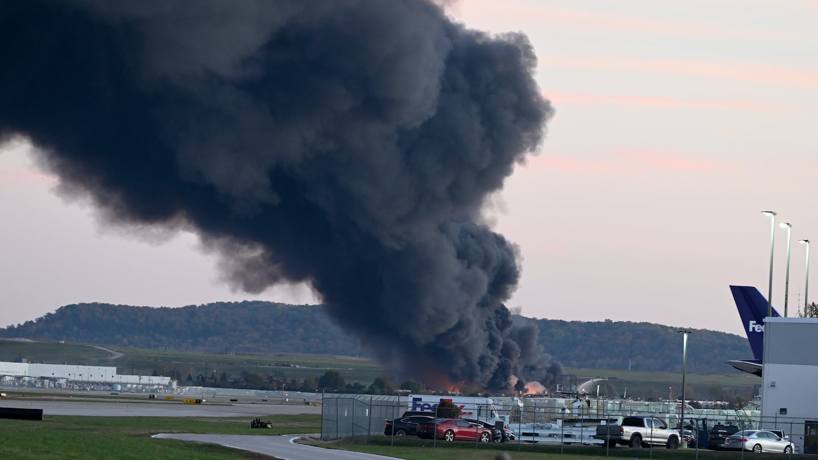 Fire and smoke mark where a UPS cargo plane crashed near Louisville Muhammad Ali International Airport on November 04, 2025 in Louisville, Kentucky.