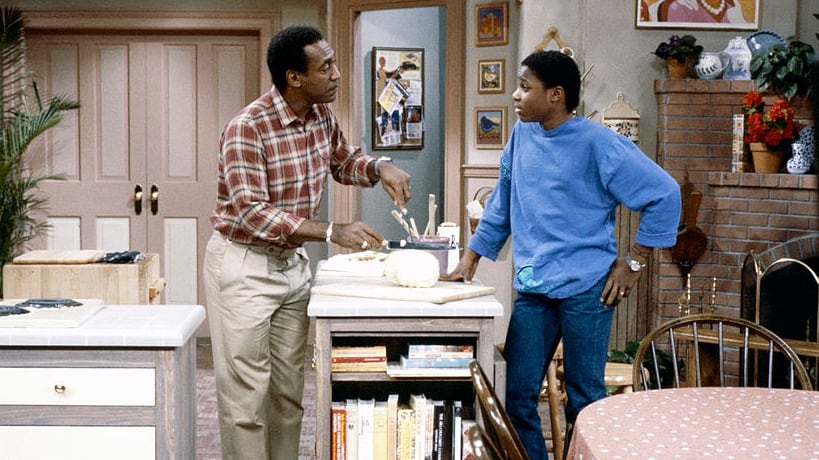 THE COSBY SHOW -- "One More Time" Episode 7 -- Air Date 11/01/1984 -- Pictured: (l-r) Bill Cosby as Doctor Heathcliff 'Cliff' Huxtable, Malcolm-Jamal Warner as Theodore 'Theo' Huxtable (Photo by R.M. Lewis Jr./NBCU Photo Bank/NBCUniversal via Getty Images via Getty Images)